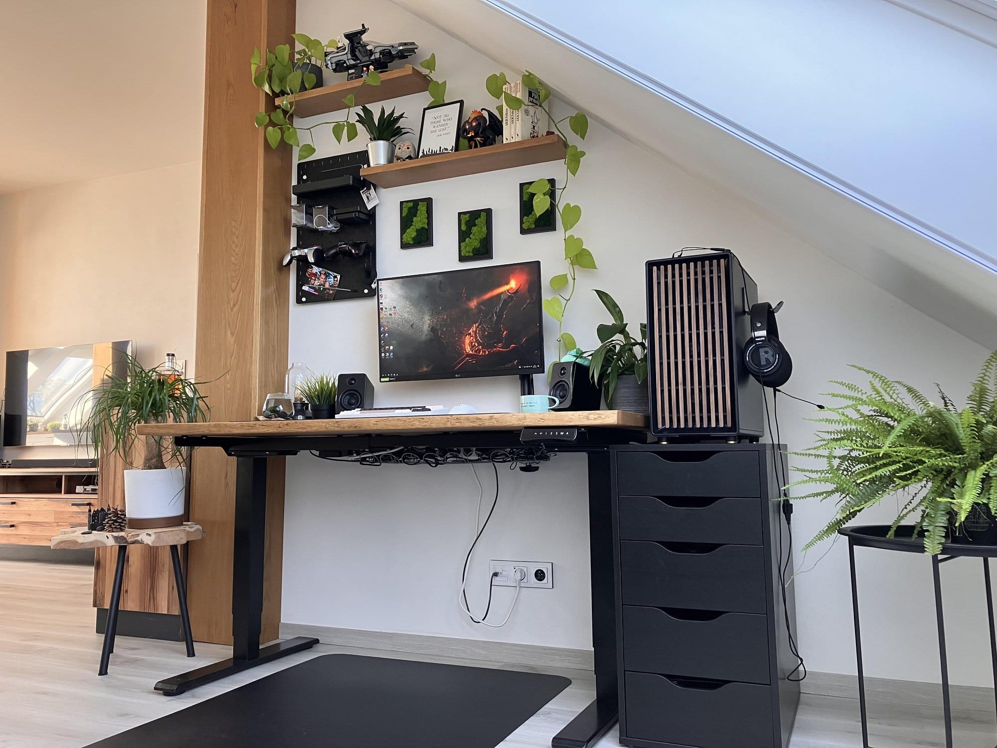 A modern home office setup featuring a wooden desk with a computer, ergonomic chair, shelves with plants and decor