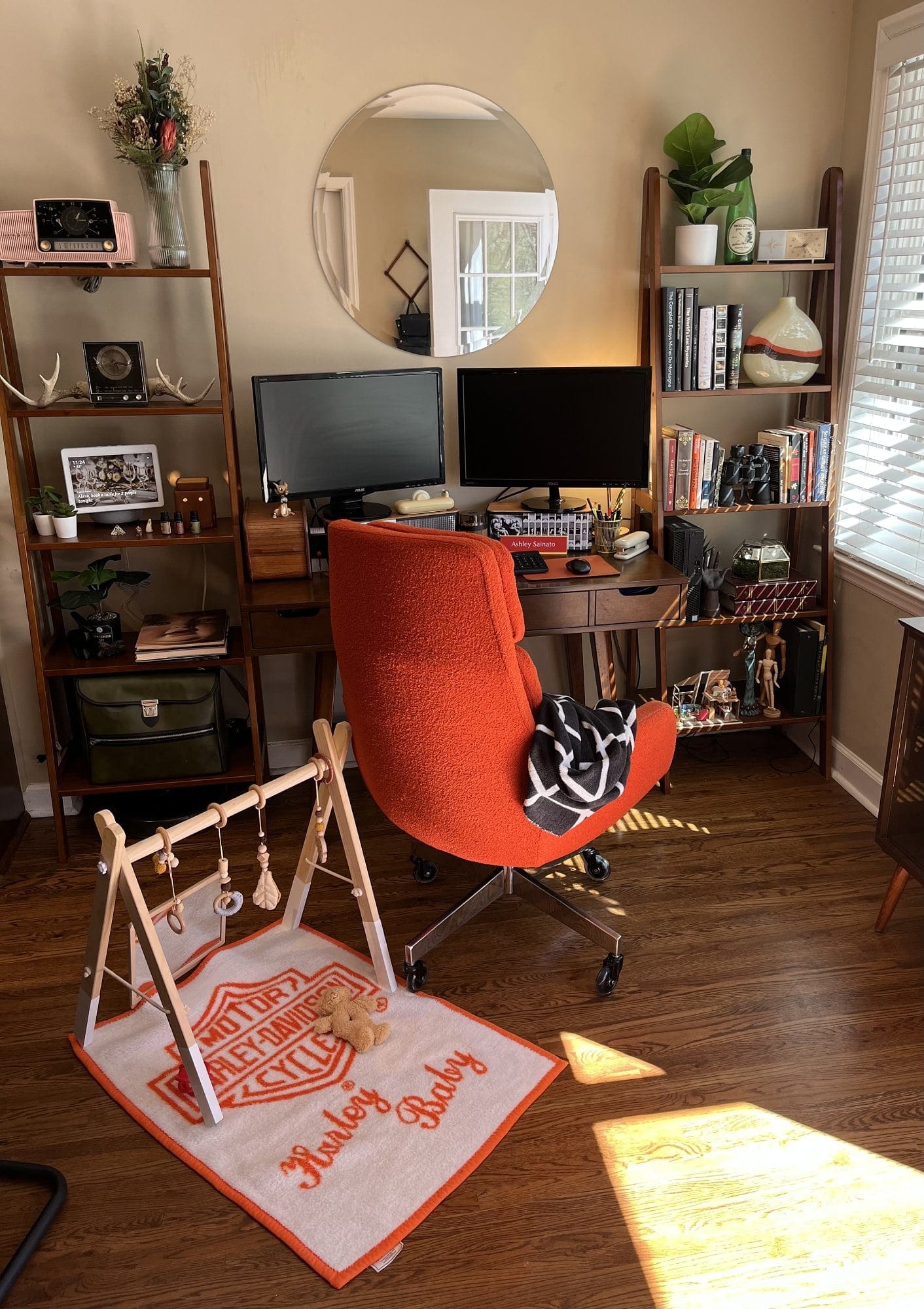 A mid-century home office of a working mom with an orange chair