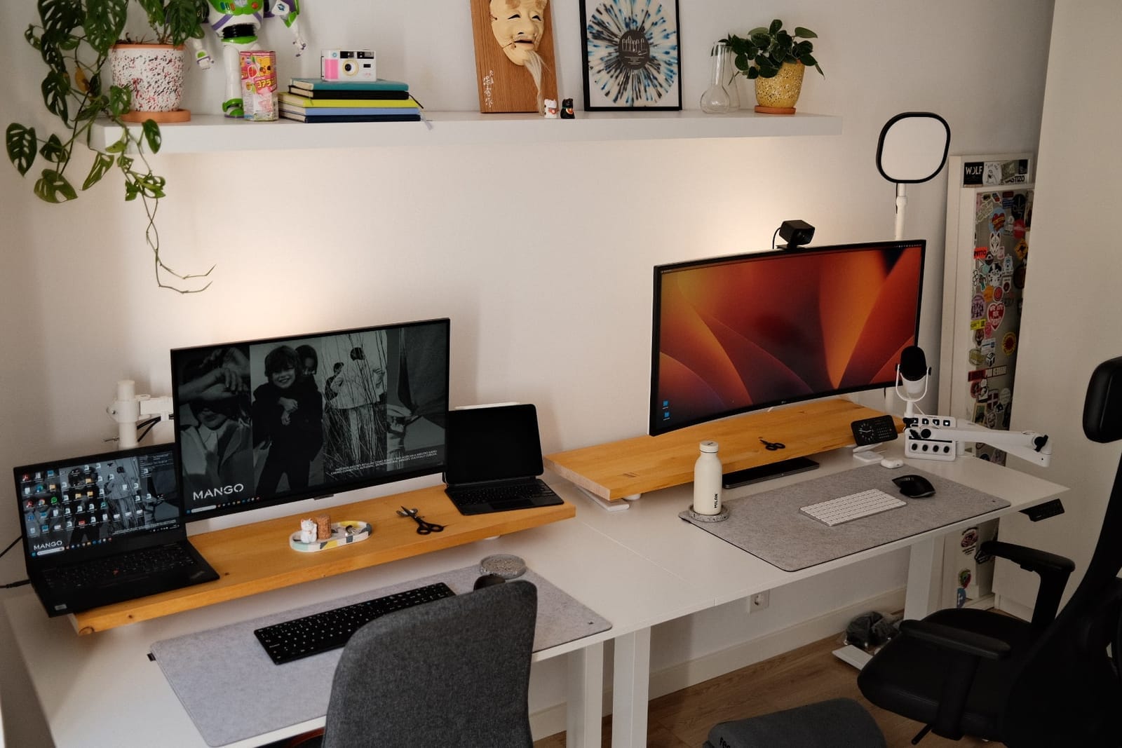 A shared home office desk setup with classic neutral white walls