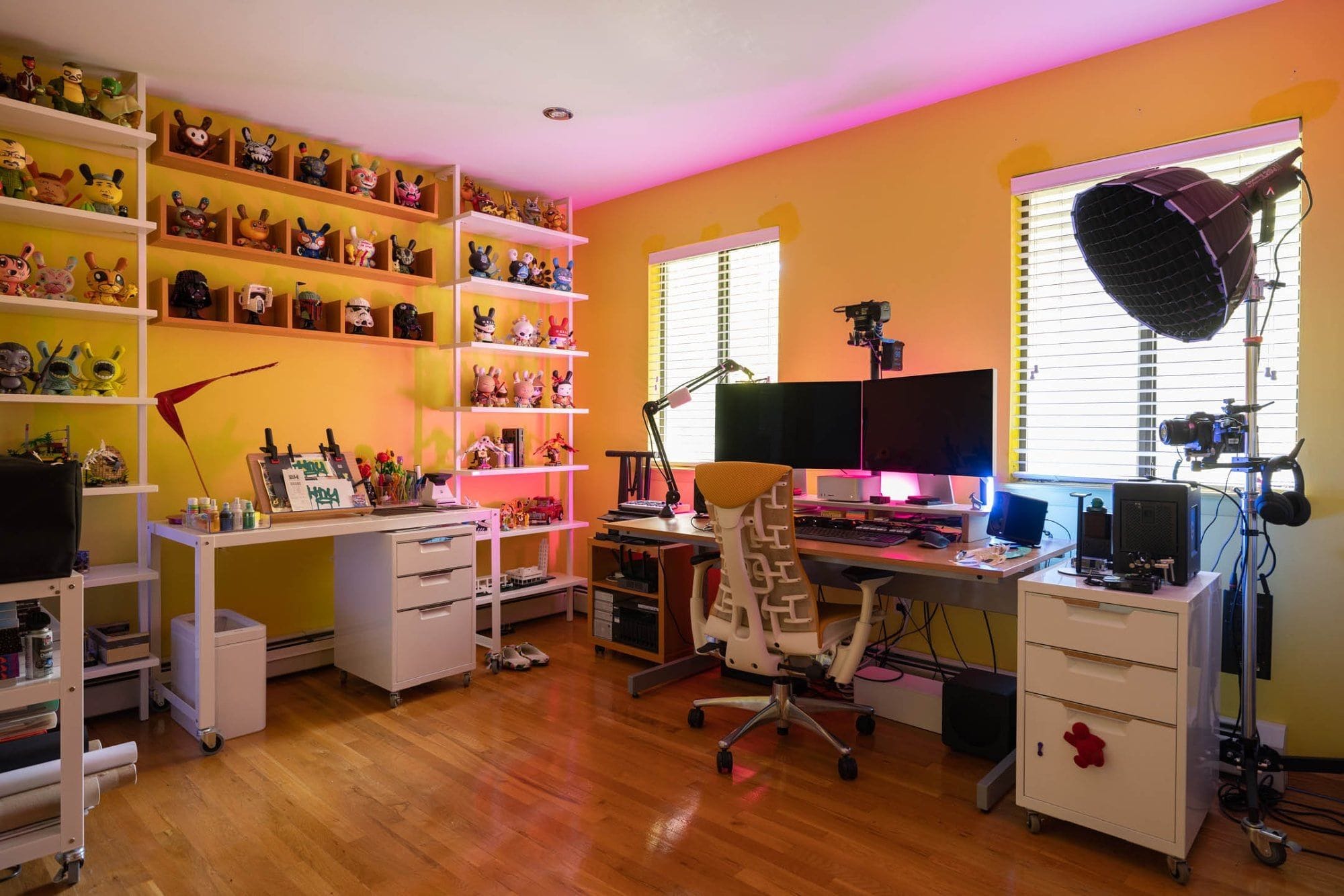 A bright yellow home office with two desk setups