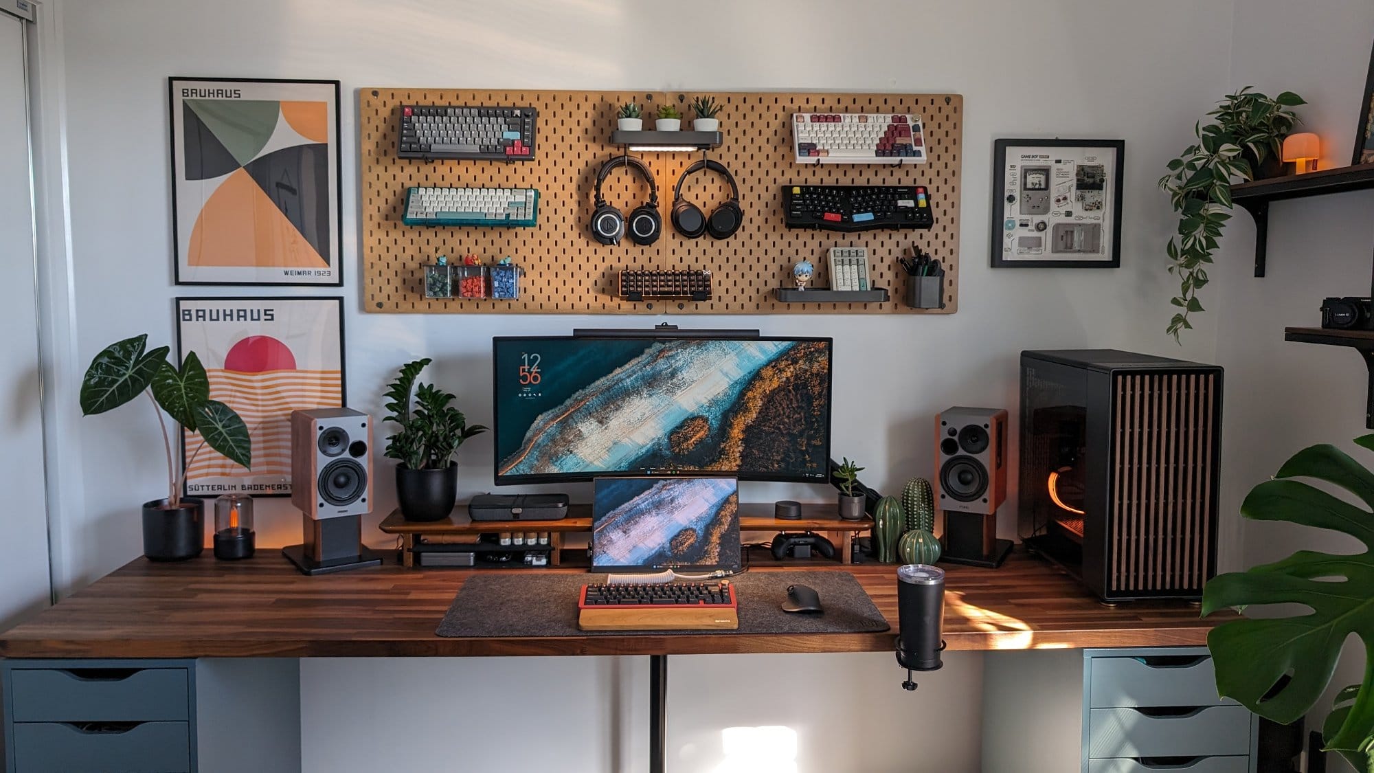 A stylish home office setup featuring an Alienware (AW3420DW) monitor, Edifier R1280DB speakers, and a Sugar65 keyboard on an IKEA KARLBY desk, with tech accessories and plants arranged for a modern, organised workspace