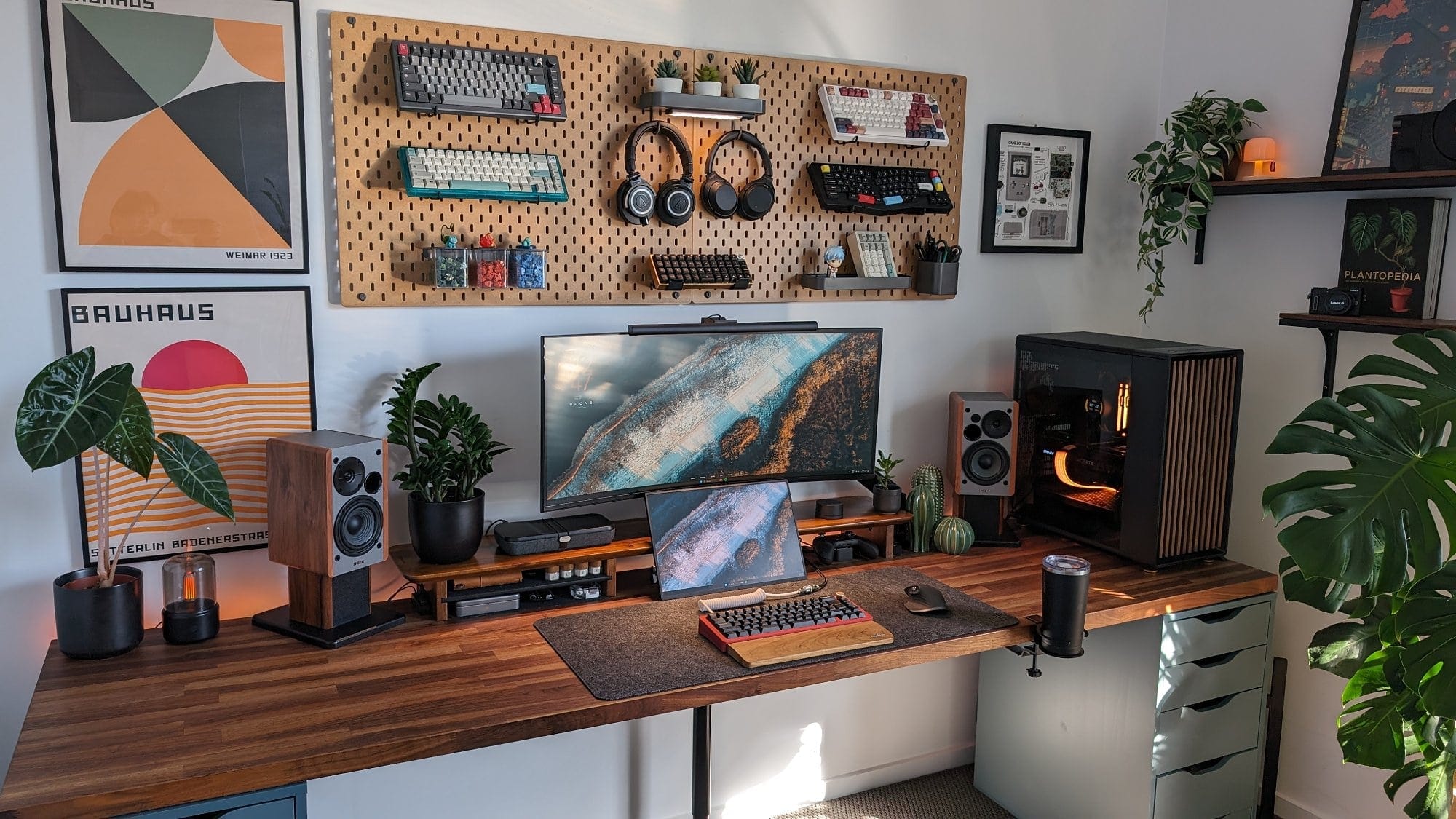 A beautifully curated home office featuring an Alienware (AW3420DW) monitor, Edifier R1280DB speakers, and an IKEA KARLBY desk adorned with vibrant green plants and well-organised tech accessories