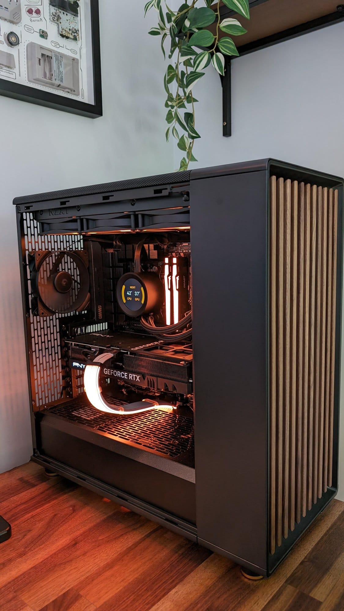 A custom-built PC setup featuring a PNY GeForce RTX graphics card, glowing warmly inside a minimalist case with wooden accents