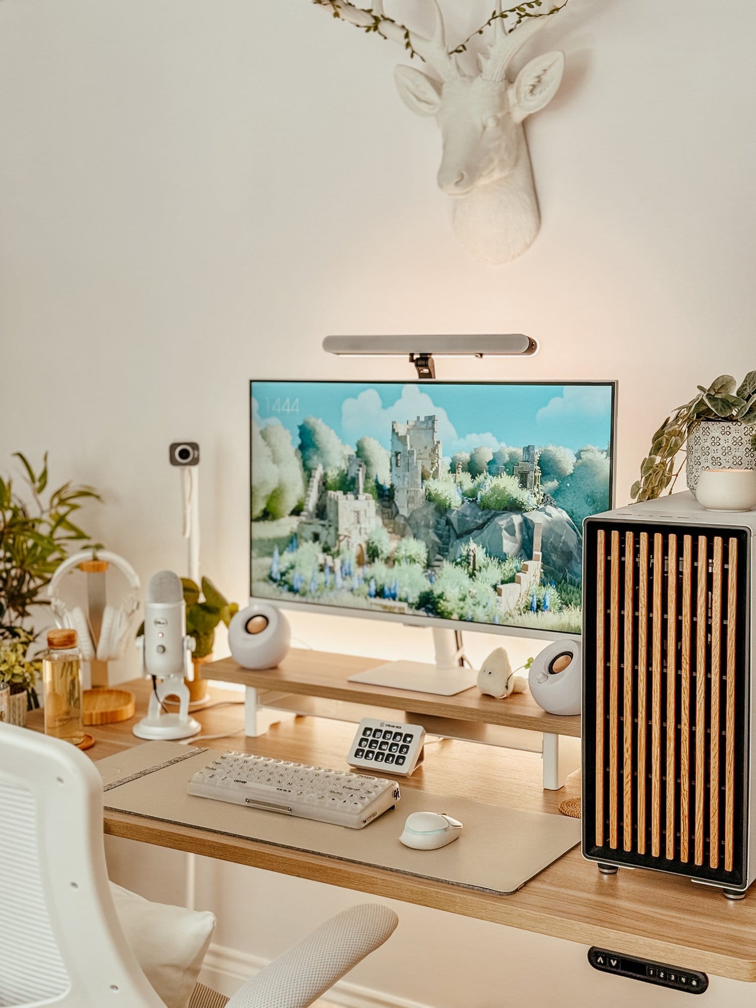 A well-organised and aesthetically pleasing workspace featuring a Samsung M7 monitor, Creative Pebble speakers, and a LoFree 1% Misty keyboard, all complemented by a North by Fractal PC tower and a Logitech G705 mouse, set on a Vernal-UK standing desk with a clean and minimalist design