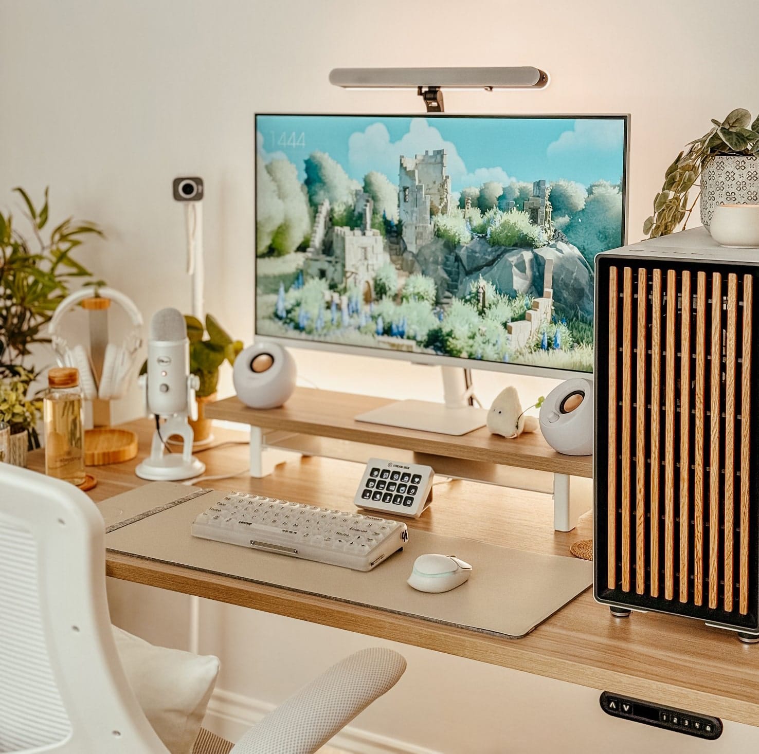 A stylish desk setup featuring a Samsung M7 monitor, Creative Pebble speakers, and a LoFree 1% Misty keyboard