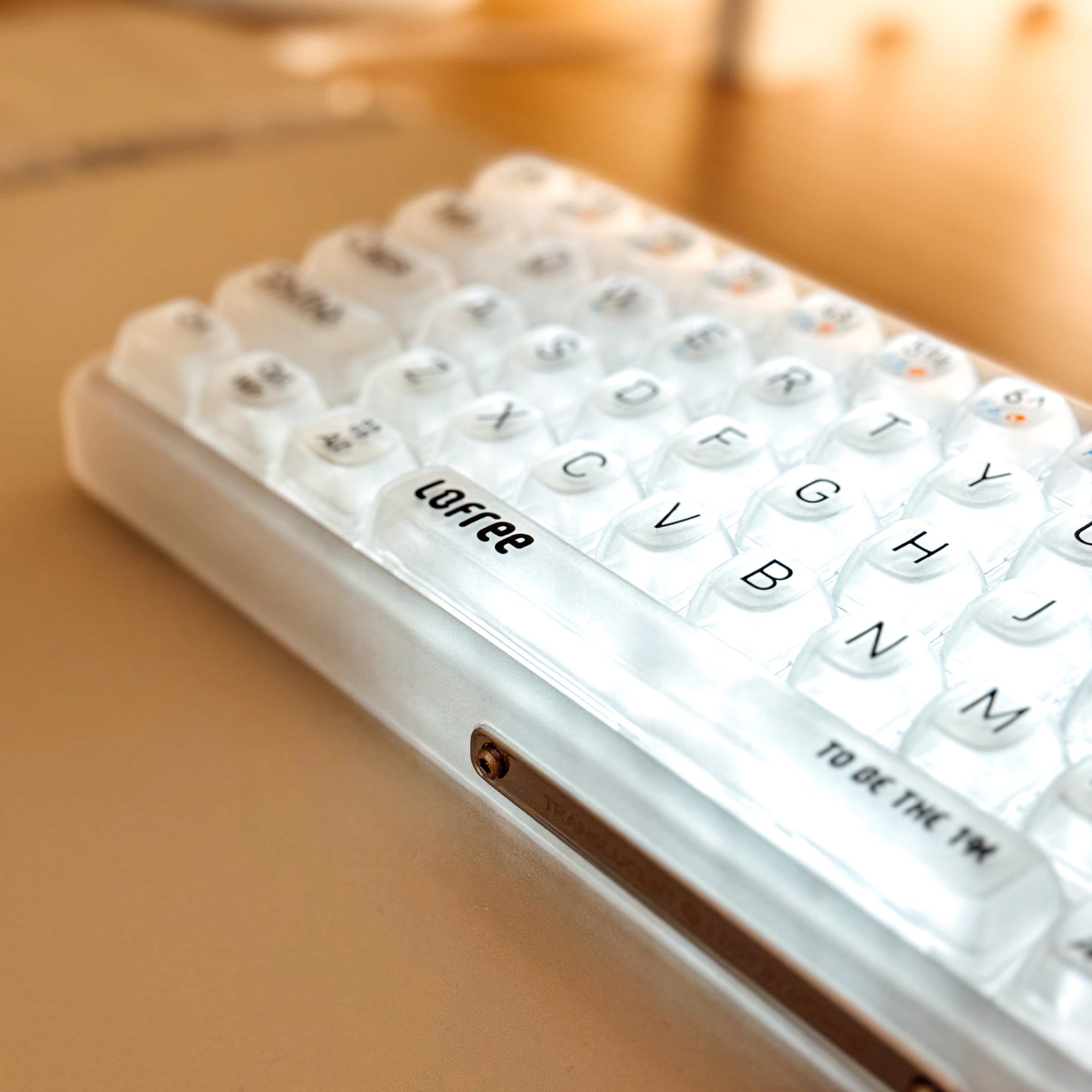 A close-up shot of the LoFree 1% Misty keyboard, highlighting its transparent keycaps and sleek design