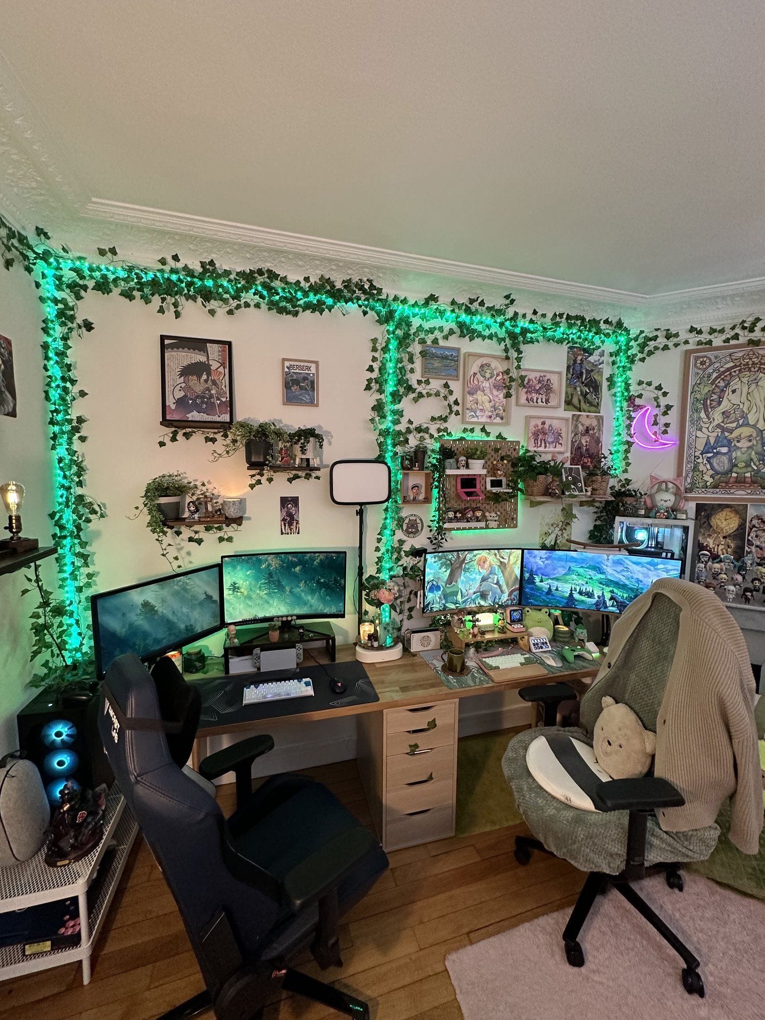 A gaming setup filled with greenery and ambient lighting, featuring dual monitors and cosy seating