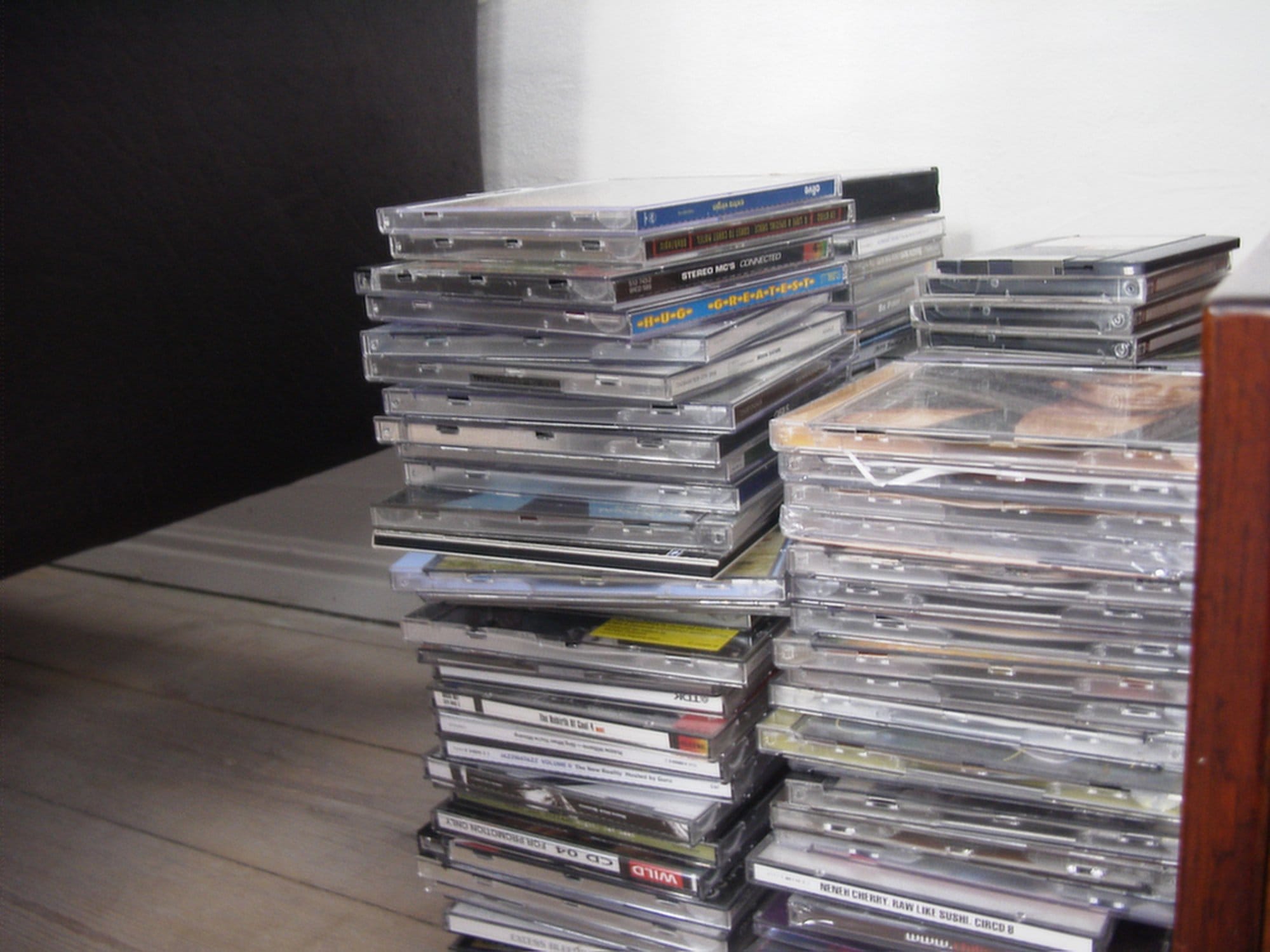 A large stack of compact disc (CD) cases