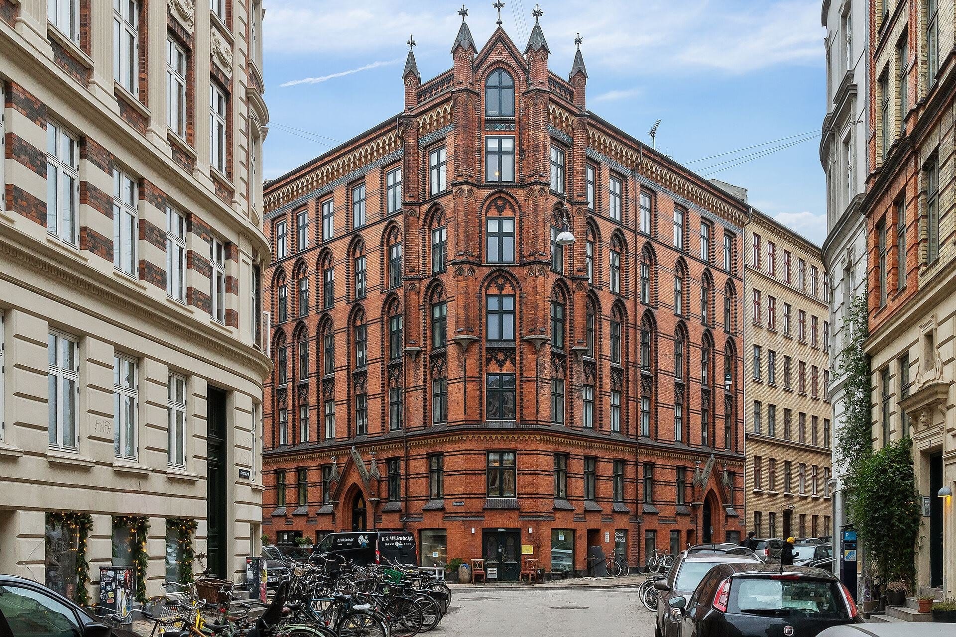 A red-brick building with intricate Gothic architectural details in Nørrebro, Copenhagen