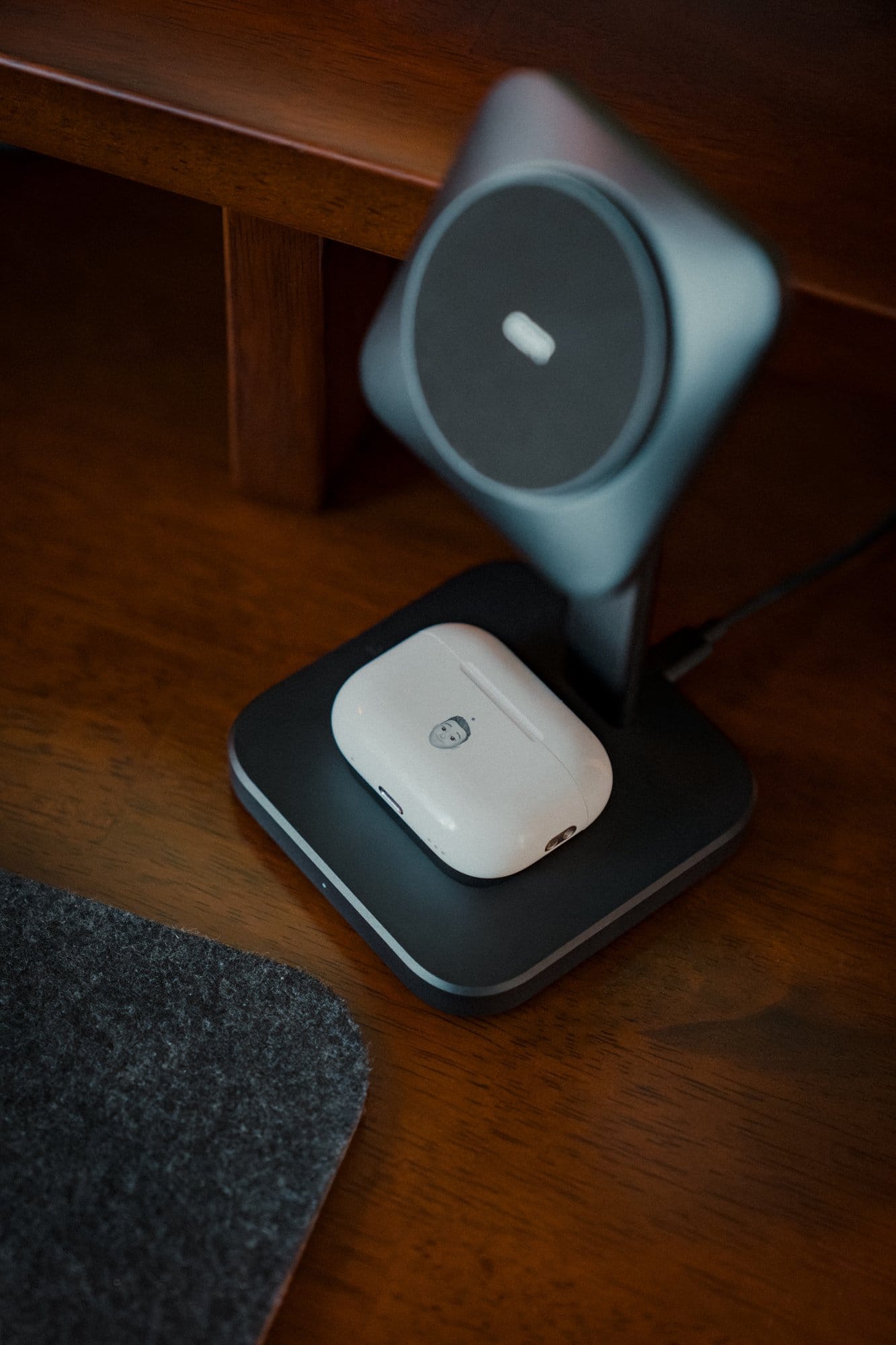 Close-up of an ESR 3-in-1 Wireless Charger Stand with MagSafe, charging a pair of AirPods Pro (2nd Generation)