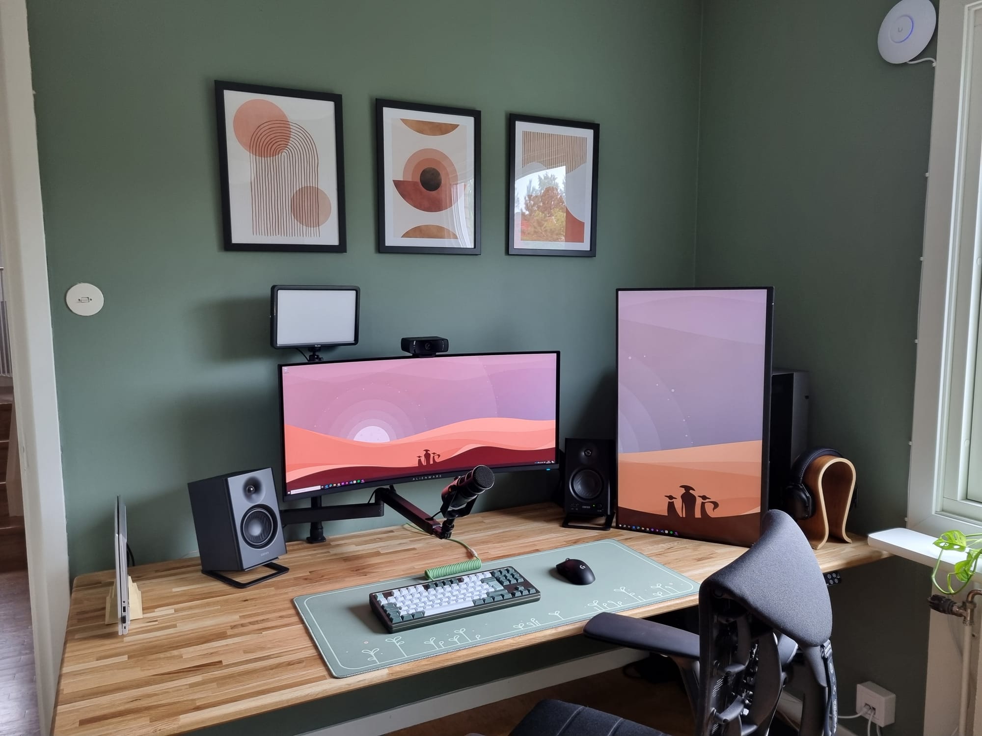 A home office setup with an Alienware AW34DWF monitor, Dell P3223QE monitor in vertical orientation, Edifier MR4 speakers, a Mode Loop TKL keyboard, Maono PD400X microphone, and a Herman Miller × Logitech Embody chair