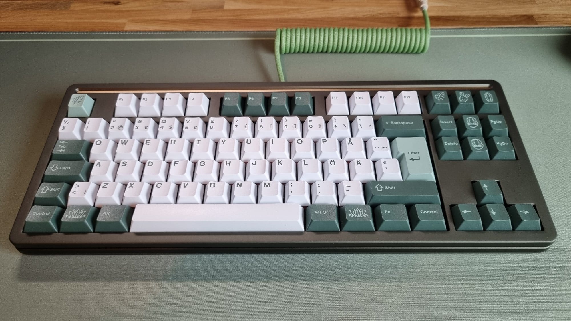 Close-up of a green mechanical Mode Loop TKL keyboard with custom keycaps