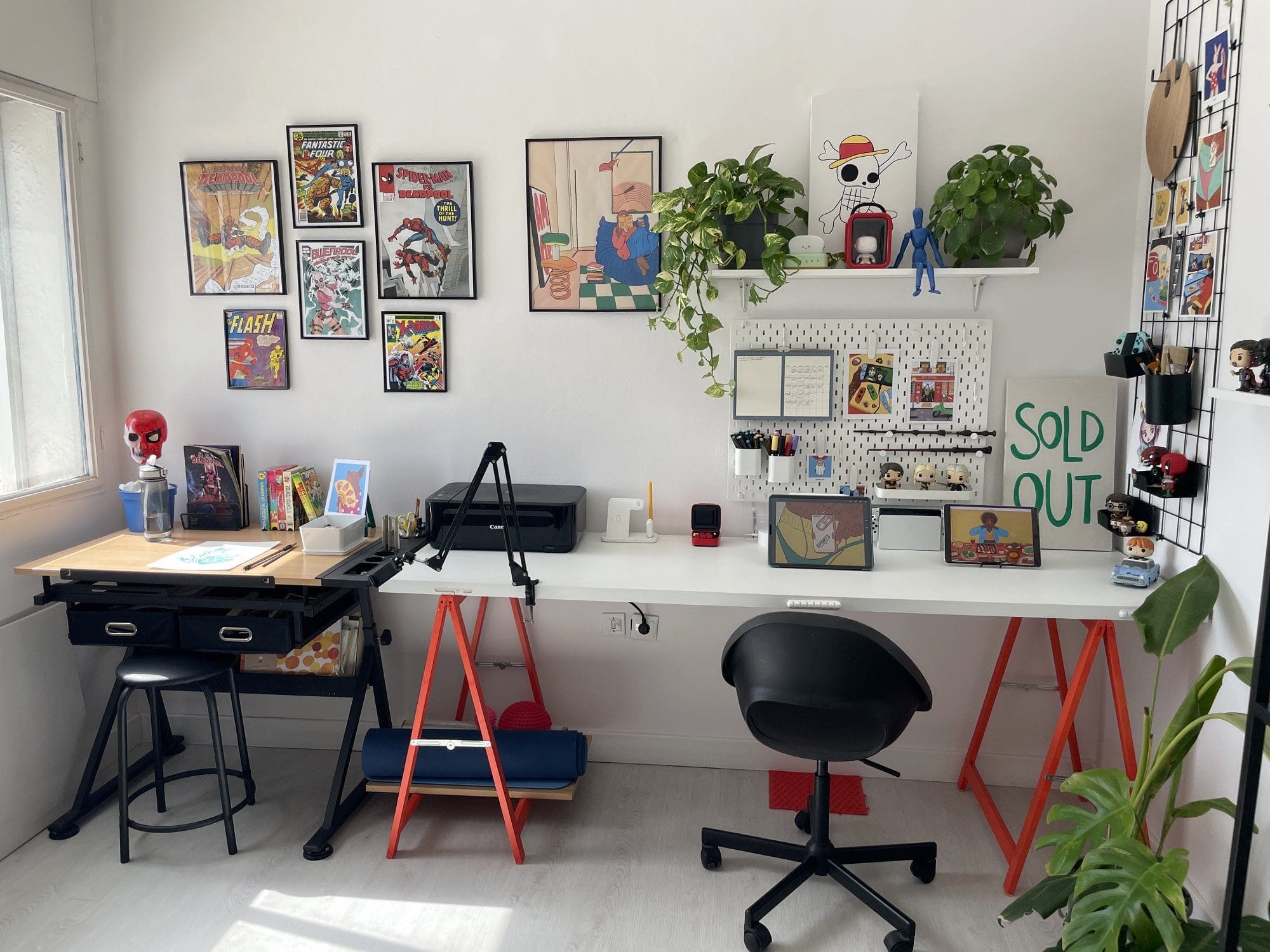 A home office desk with an iPad Pro 12.9″, an OMOTON Wireless keyboard, and a Canon MG 3650S printer, set against an IKEA SKÅDIS pegboard organised with accessories