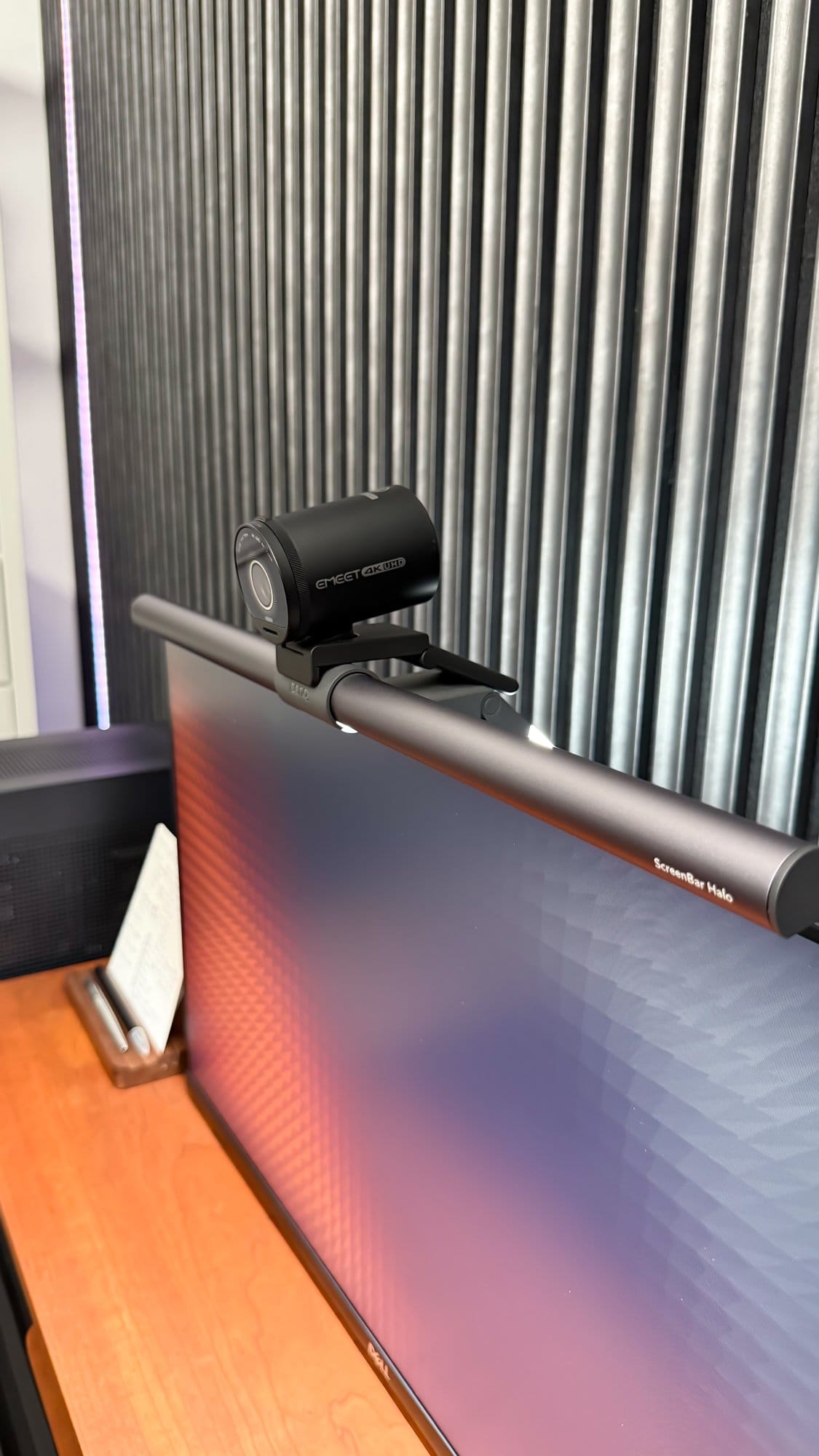 A close-up of an Emeet S800 4K webcam mounted on a BenQ Screenbar Halo, positioned on top of a Dell monitor with an acoustic panel in the background