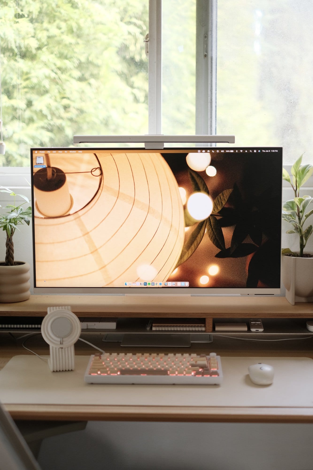 A desk setup by a window with a Samsung monitor on a large Grovemade desk shelf, a Keychron Q1 V2 keyboard, and a Logitech G305 mouse