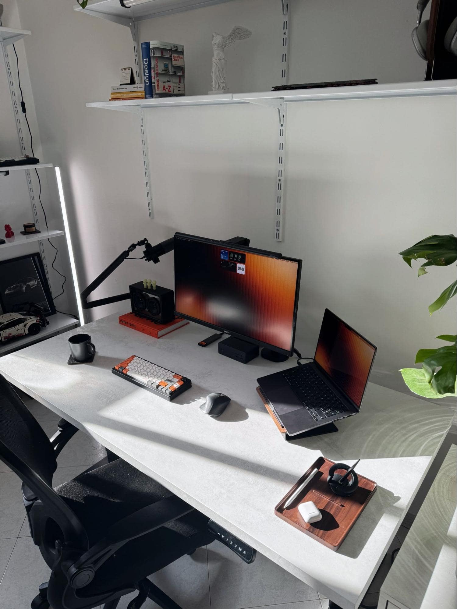 A home office setup, showcasing an Acer XV272UP monitor, a MacBook Pro 14″ M3 Pro on a laptop stand, and a Keychron K3 Max keyboard on a white desk, with a FIFINE K688 microphone on an adjustable arm