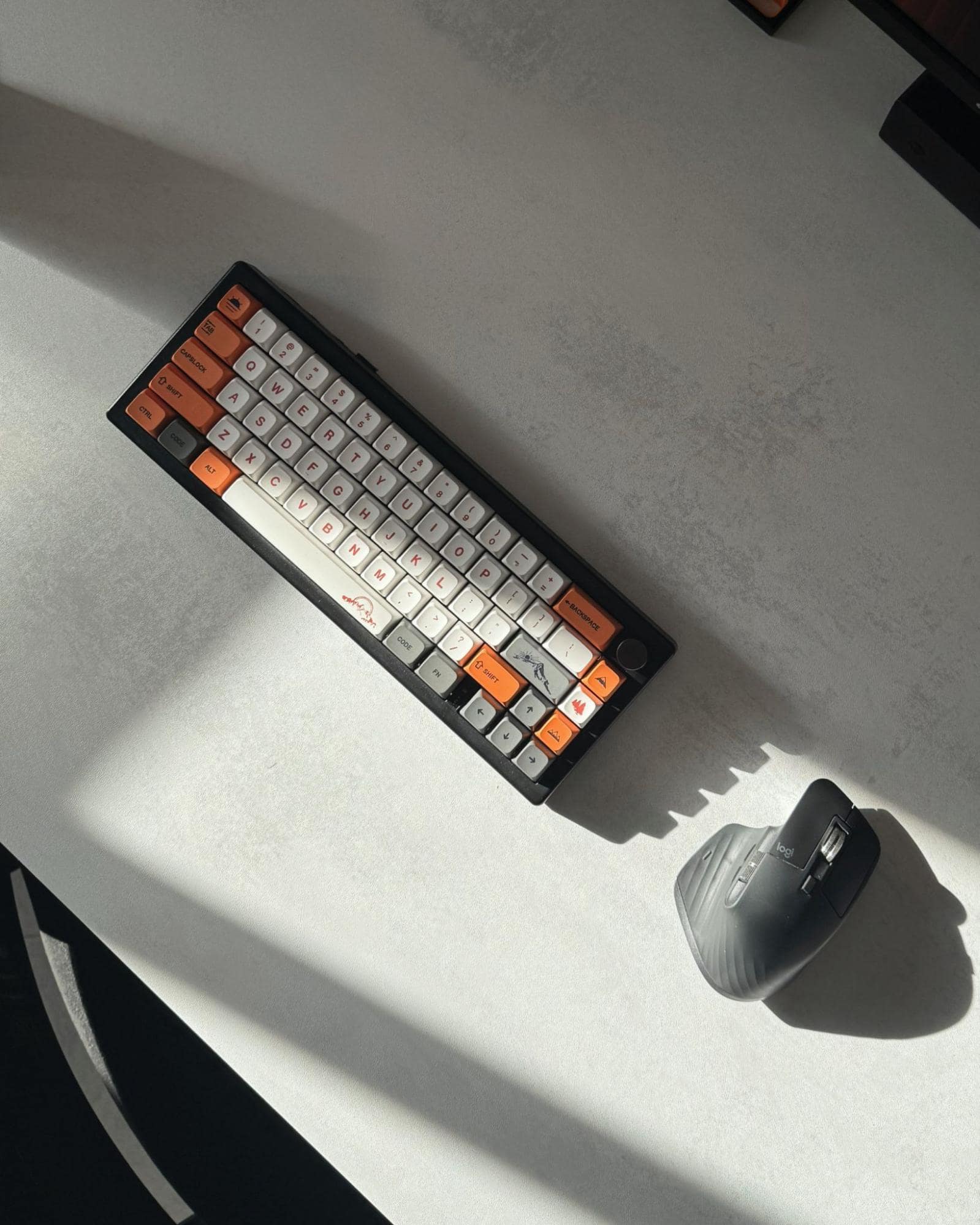 A close-up shot of a Keychron K3 Max keyboard and a Logitech MX Master 3S mouse on a white desk