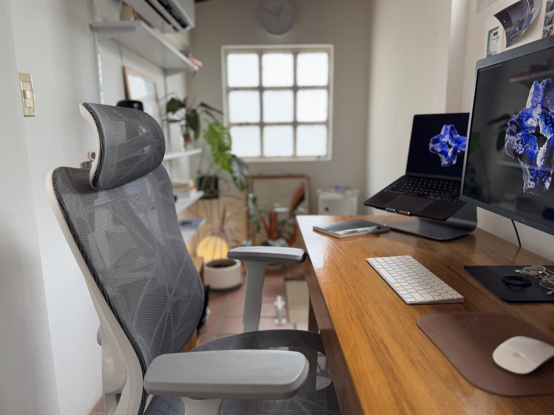 A desk setup with an Actek Floe Plus EC727 chair, an Apple MacBook Pro M3 Pro, an LG UltraFine 4K monitor, an Apple Keyboard, and an Apple Magic Mouse