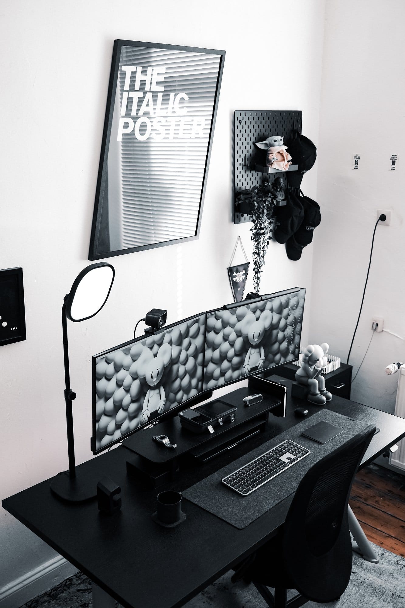 A dual Dell monitor workspace setup with a “THE ITALIC POSTER” print on the wall