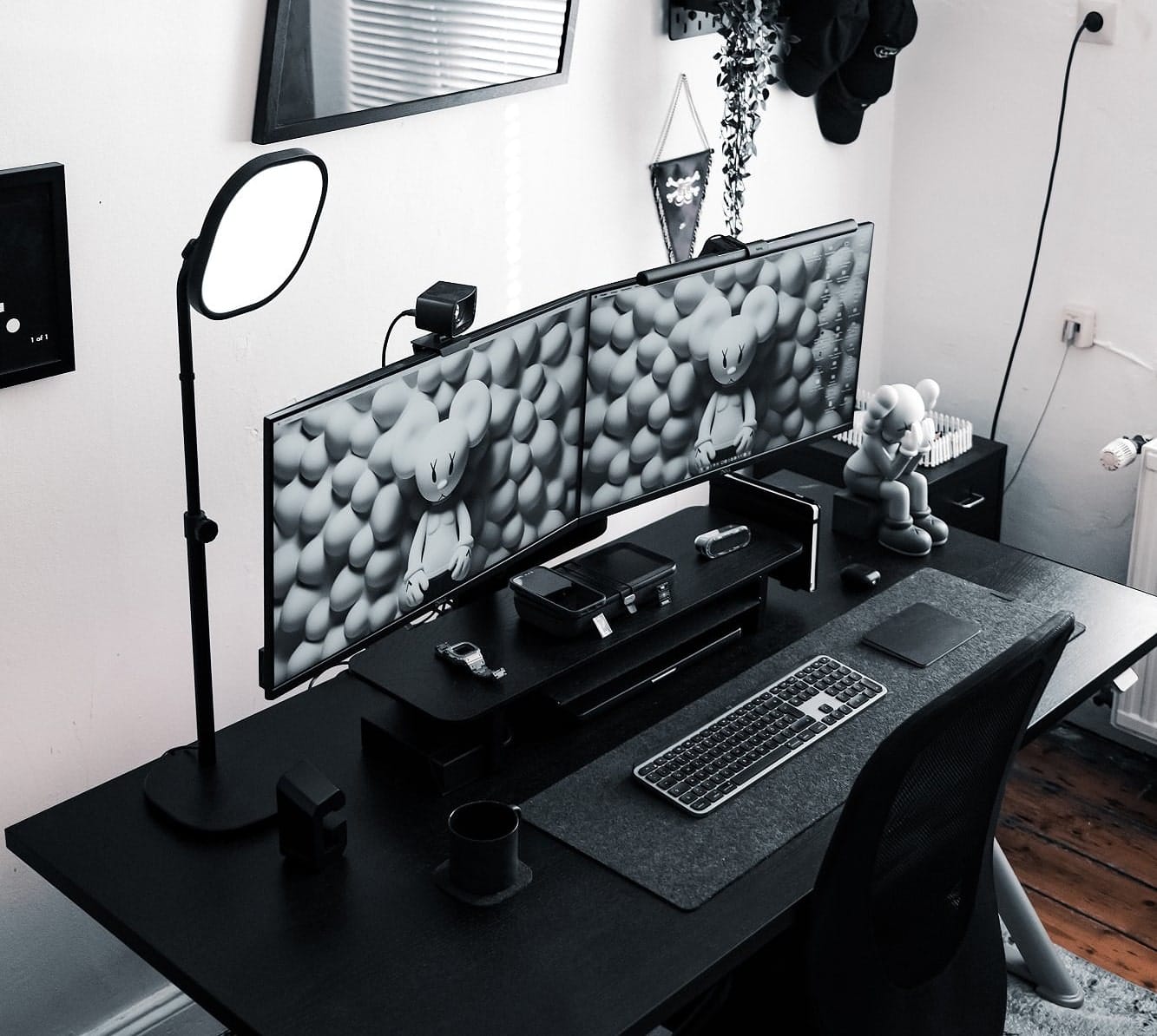 A black and white home office setup with two monitors